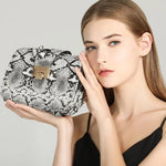 black, grey and white snakeskin bag