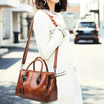 Brown leather shoulder bag with triple pocket compartment