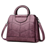 Purple leather crossbody purse with lots of compartments