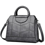 Gray leather crossbody purse with lots of compartments