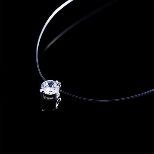 Side view of diamond pendant with transparent necklace