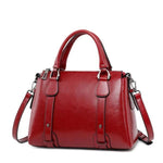 Red leather crossbody purse with handles