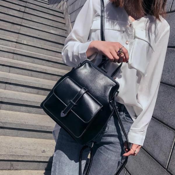 Model posing with black Deborah, Luxury Convertible Backpack for Women
